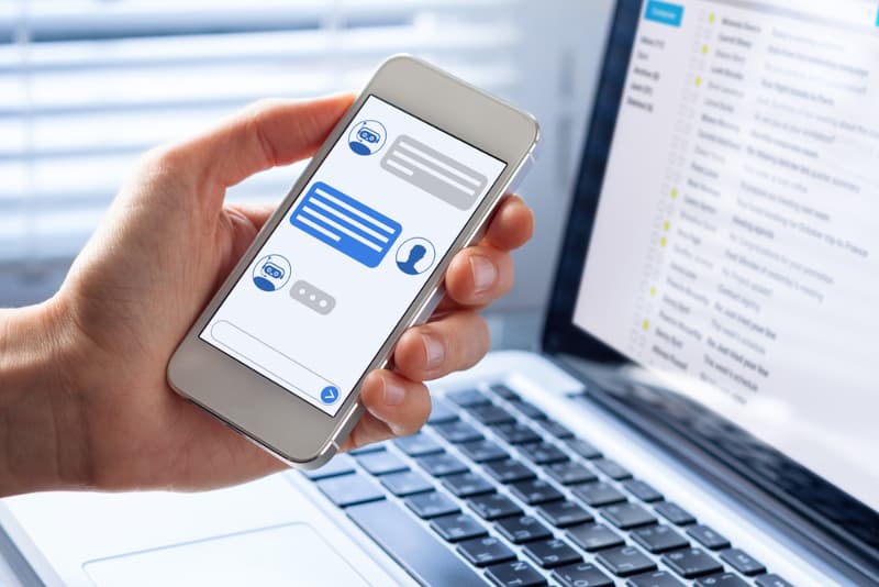 virtual assistant customer support and information, person hand holding mobile phone
