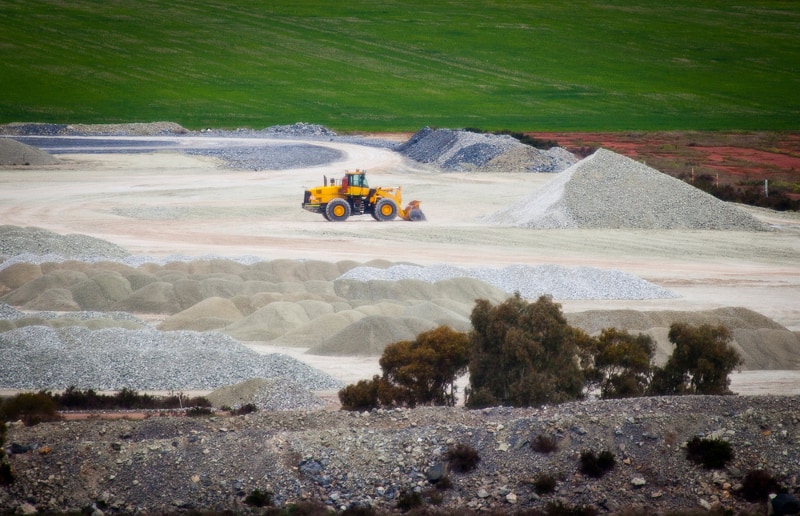 Talc mine in Western Australia. Bulldozer makes a pile of hydrated magnesium silicate.