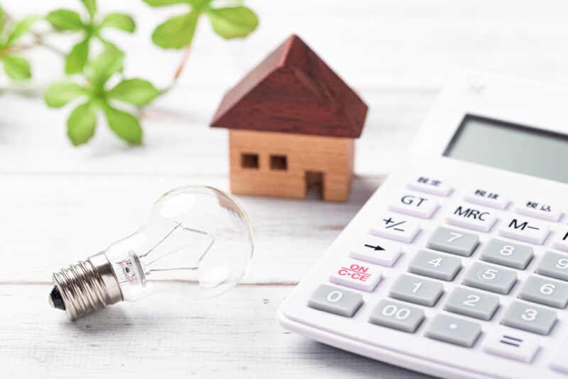 Light bulb, calculator and house