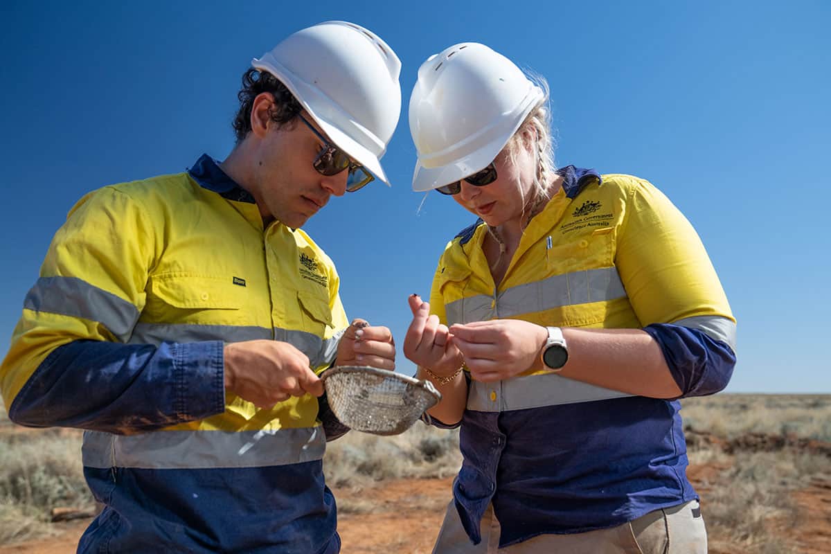 Geoscientists Liam and Holly examine rock and soil uncovered as part of the drilling operation