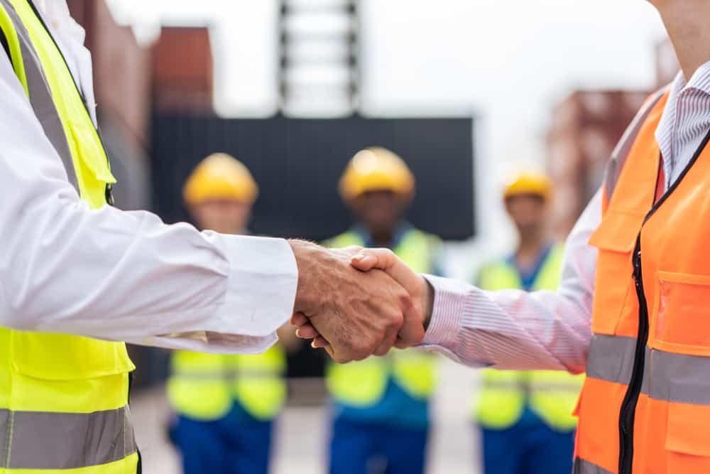 Workers shaking hands.